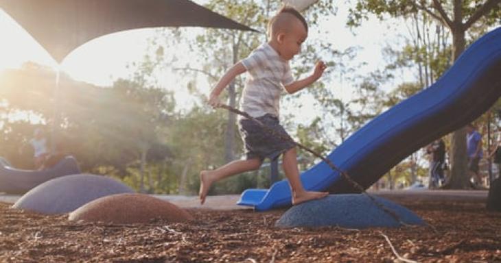 A child plays on an outdoor playground