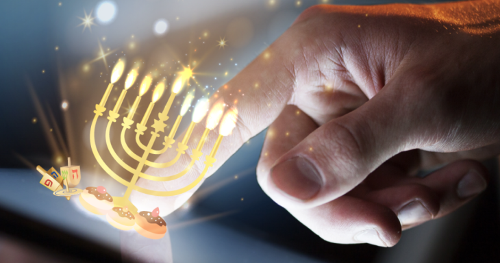 A hand tapping a virtual menorah sitting on a smart device