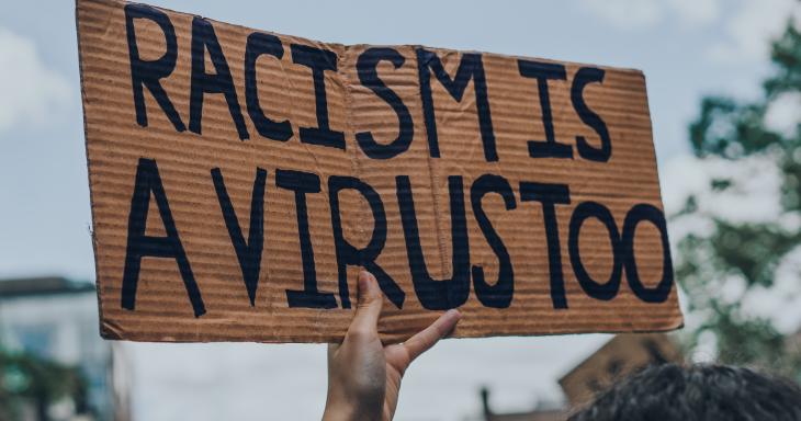 Racism is a Virus, too protest sign