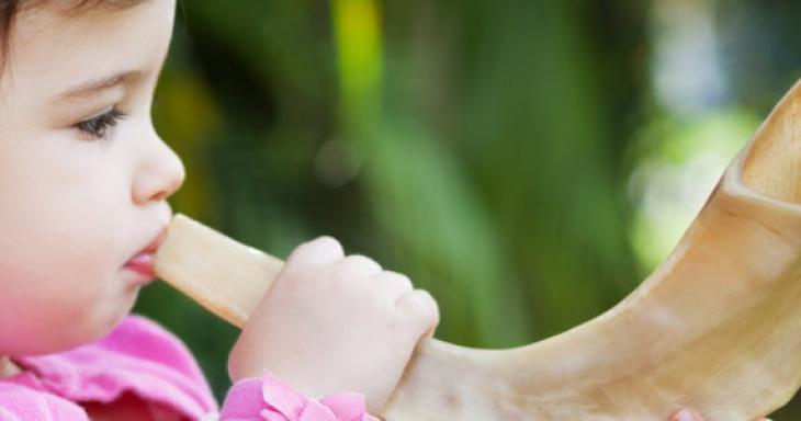 Girl blowing shofar