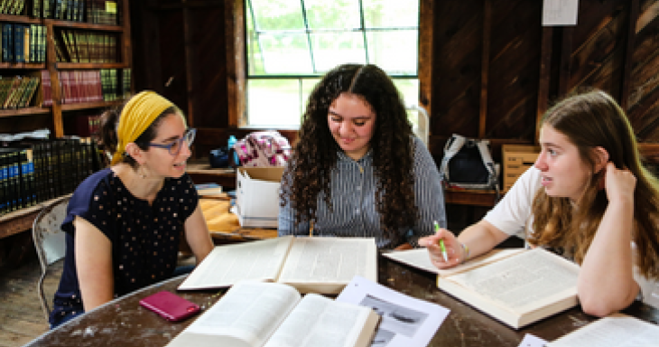 Women study Jewish text together inside