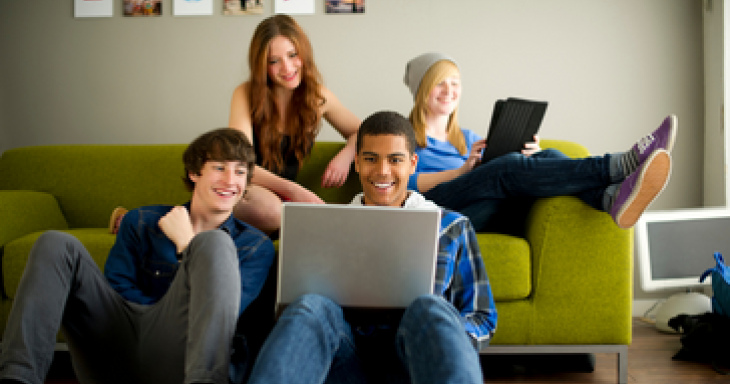 Teenagers sitting down on a couch