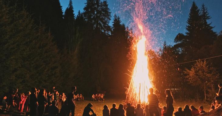 A bonfire with people gathered around