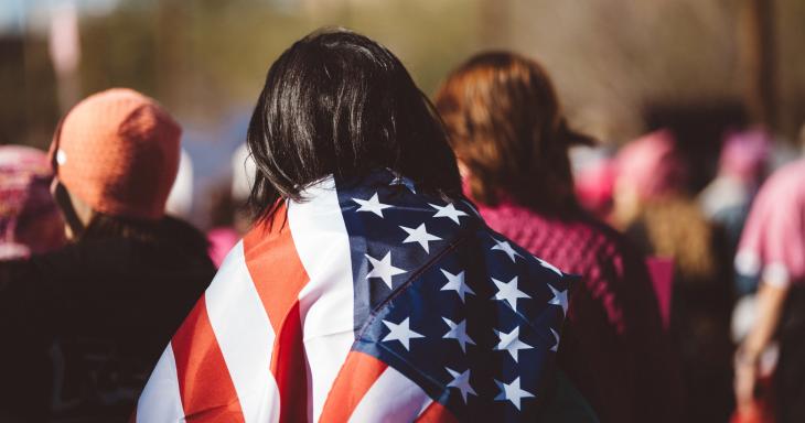 Woman in a crowd with US flag