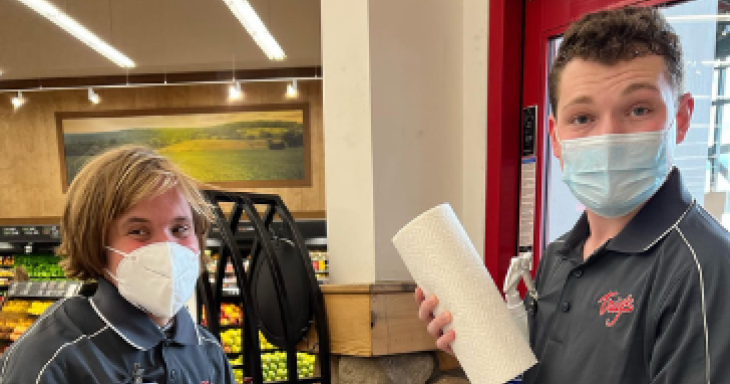 Two people working at a grocery store