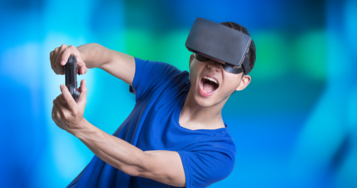 A teen boy with a VR headset and controller with a blue background