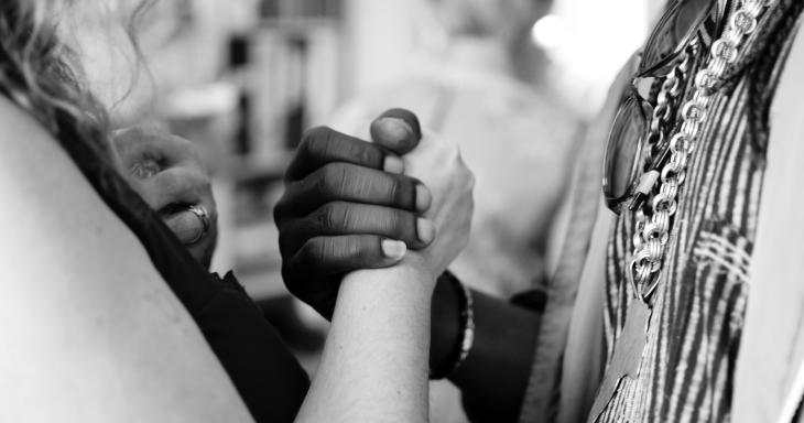 Two people shaking hand emphatically. 