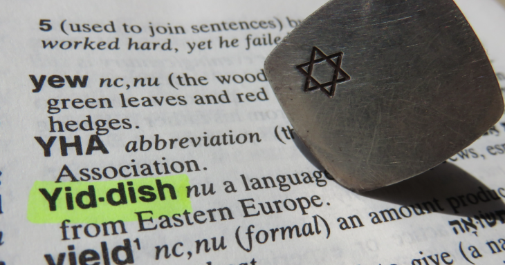 Yiddish highlighted in the dictionary with a paper weight that has the Star of David on it