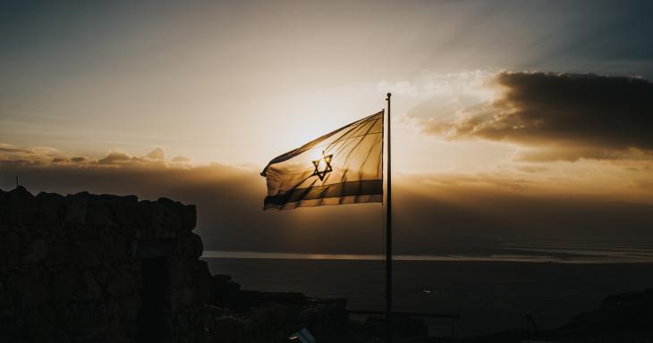 Israeli flag waving in sunset