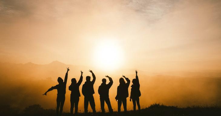 kids in front of a sunset