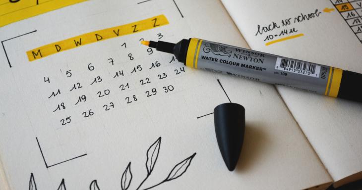A hand-written calendar and a highlighter. 