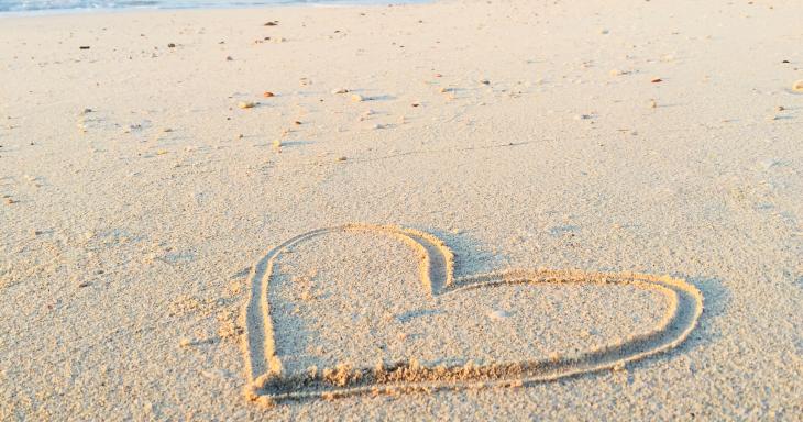 A heart drawn in sand on a beach
