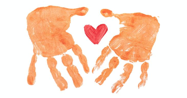 Painted handprints with a painted heart between them