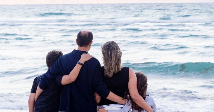 Family hugging at beach