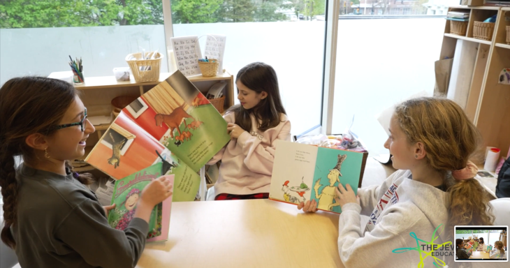 Kids learning over picture books at Mayim