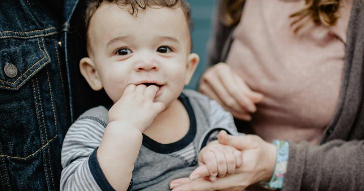 Baby held by parents