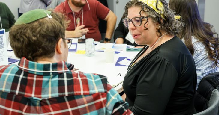 People sitting and discussing ideas in a seminar. 