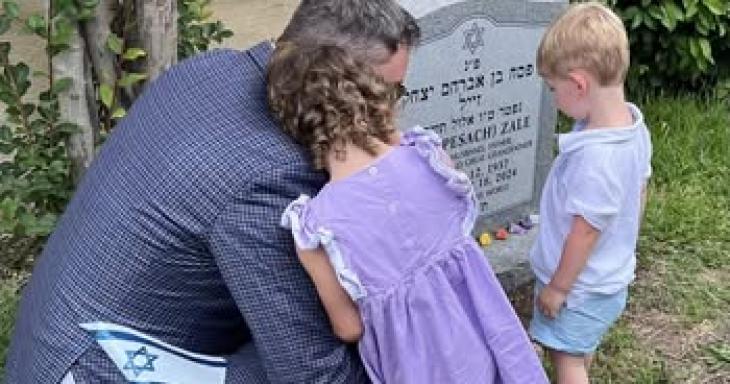 Father and children visit grandparent grave