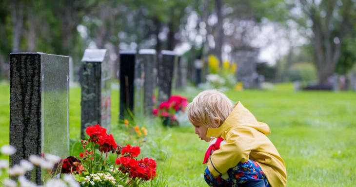Little Boy in Front of Headstone
