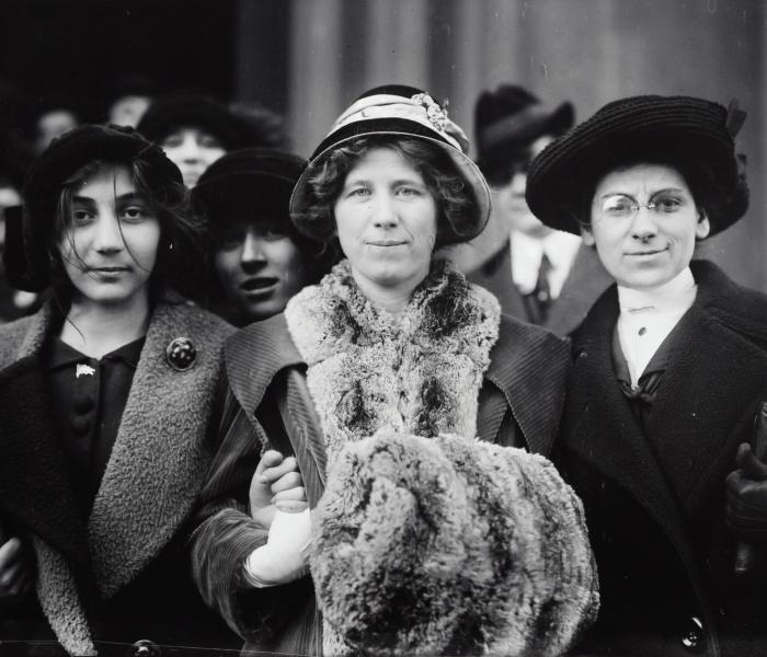 Suffragettes standing together during strike