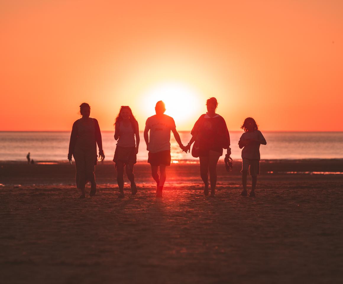 people walking in sunset light