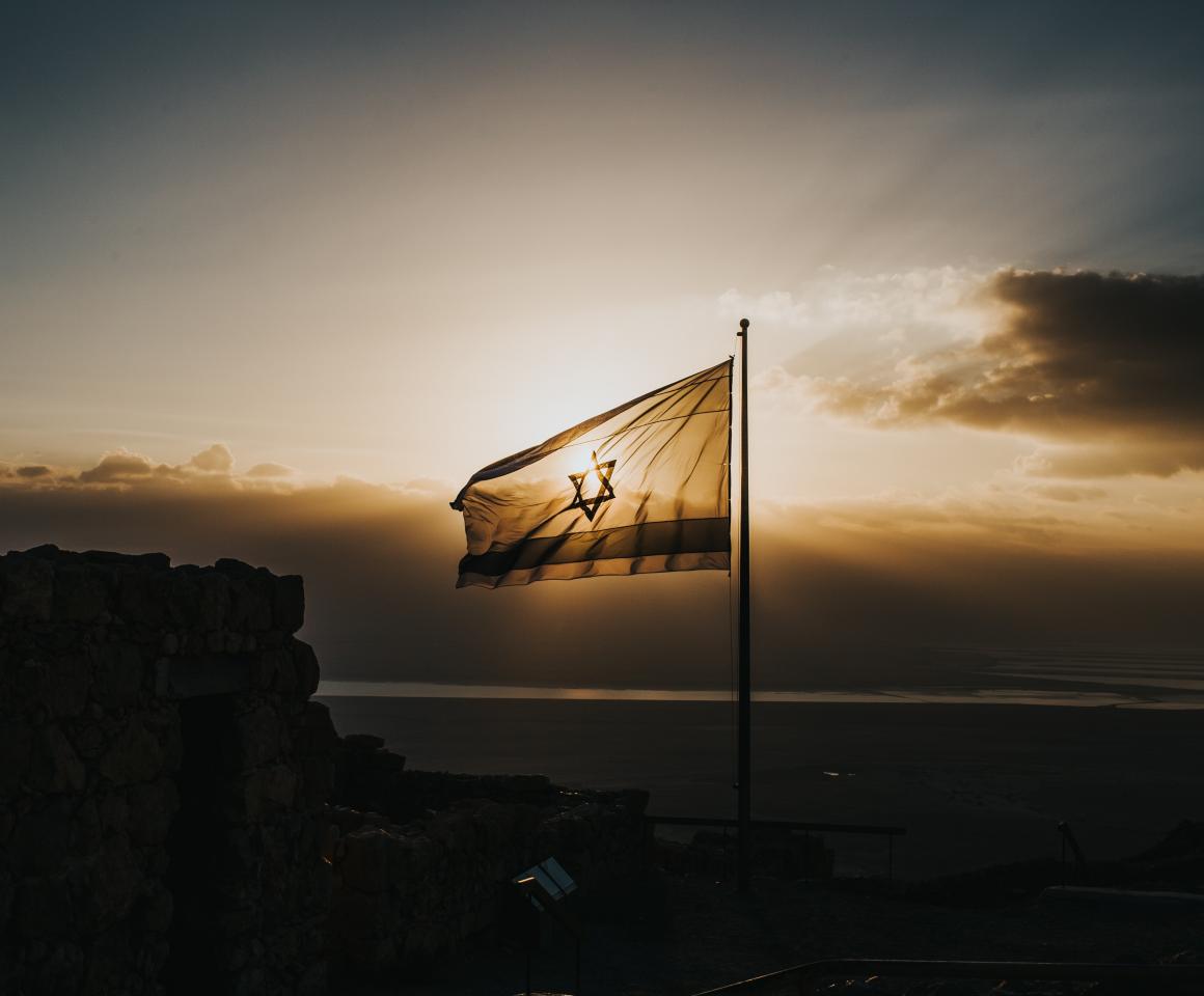 Israeli flag waving in sunset