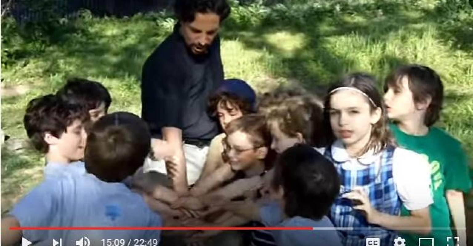 The High Five (video still with group hands)