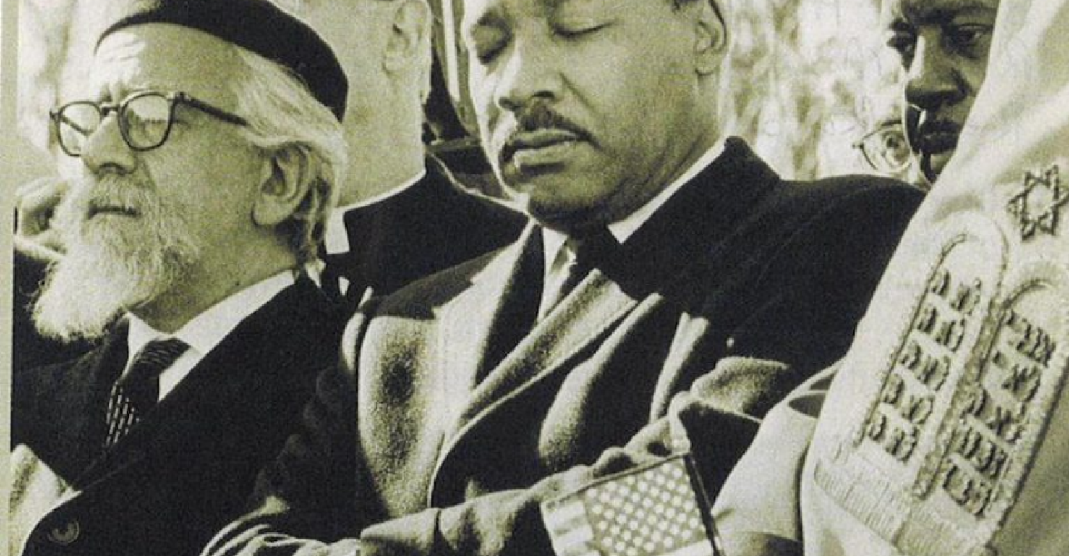 MLK and Rabbi Heschel marching together with a Sefer Torah