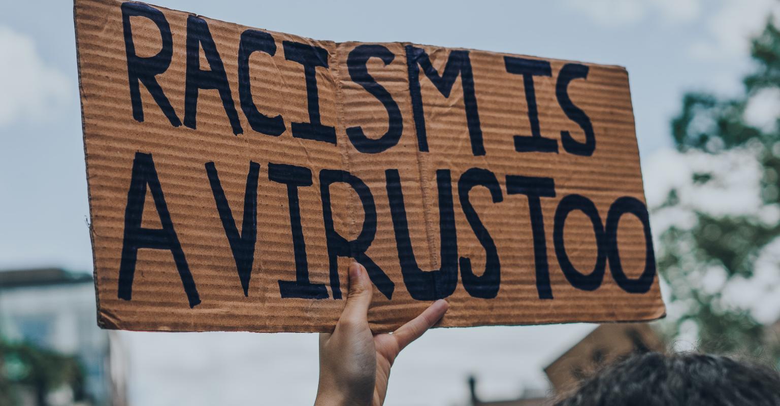 Racism is a Virus, too protest sign