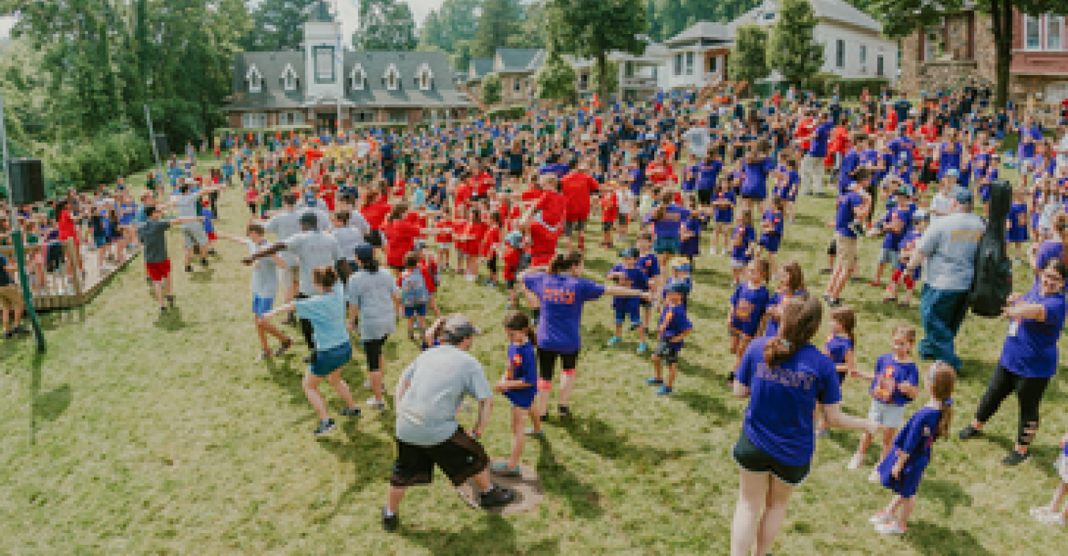 Adults and children on a field