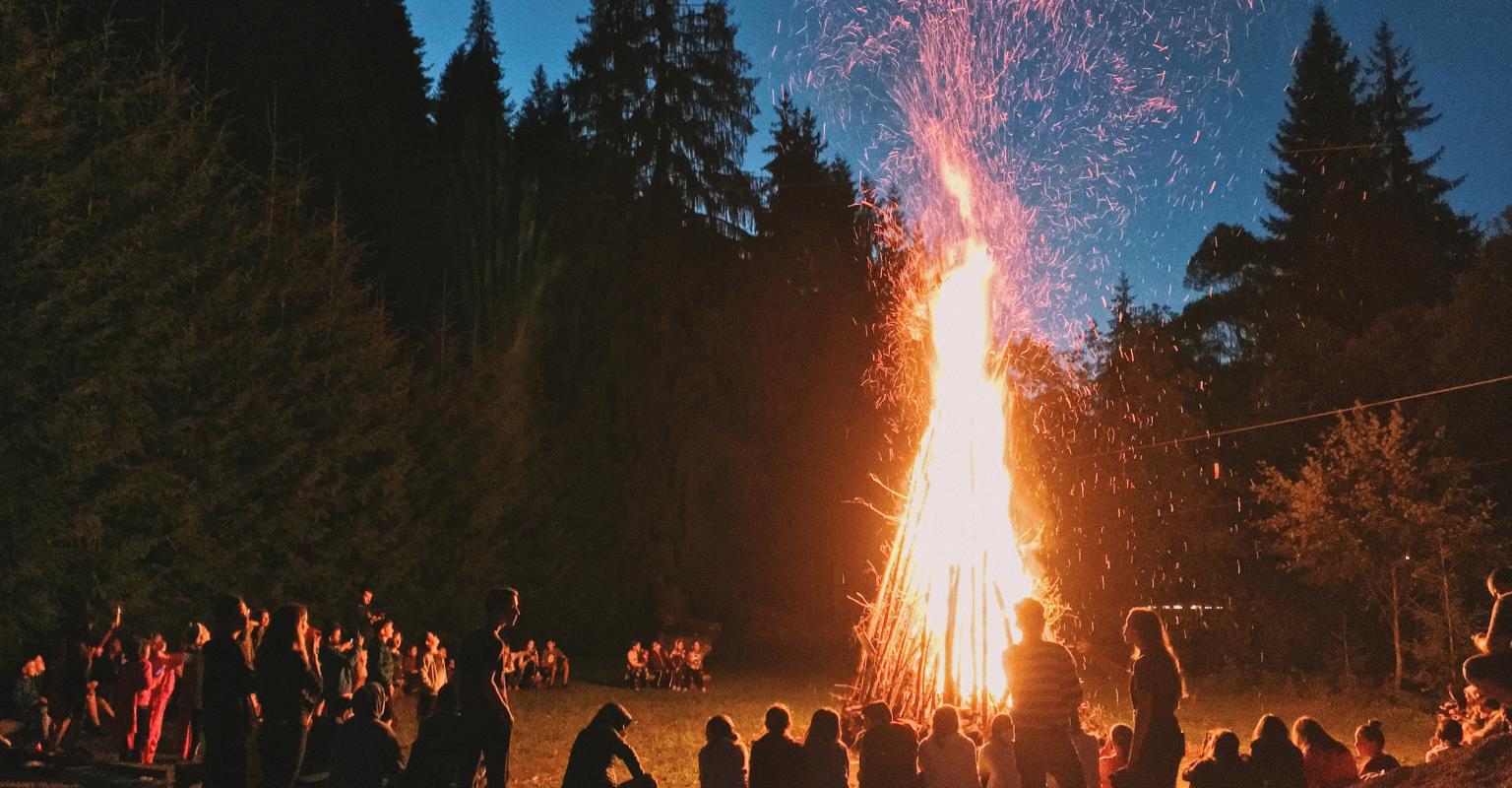 A bonfire with people gathered around