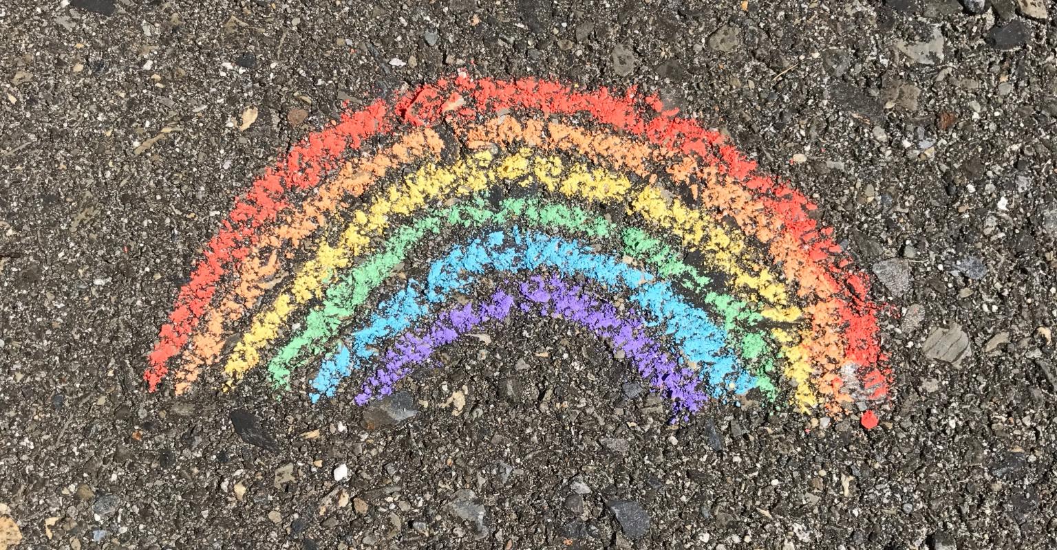 Rainbow drawn in chalk on sidewalk