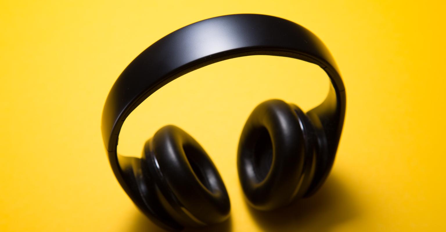 Black earphones on a yellow background