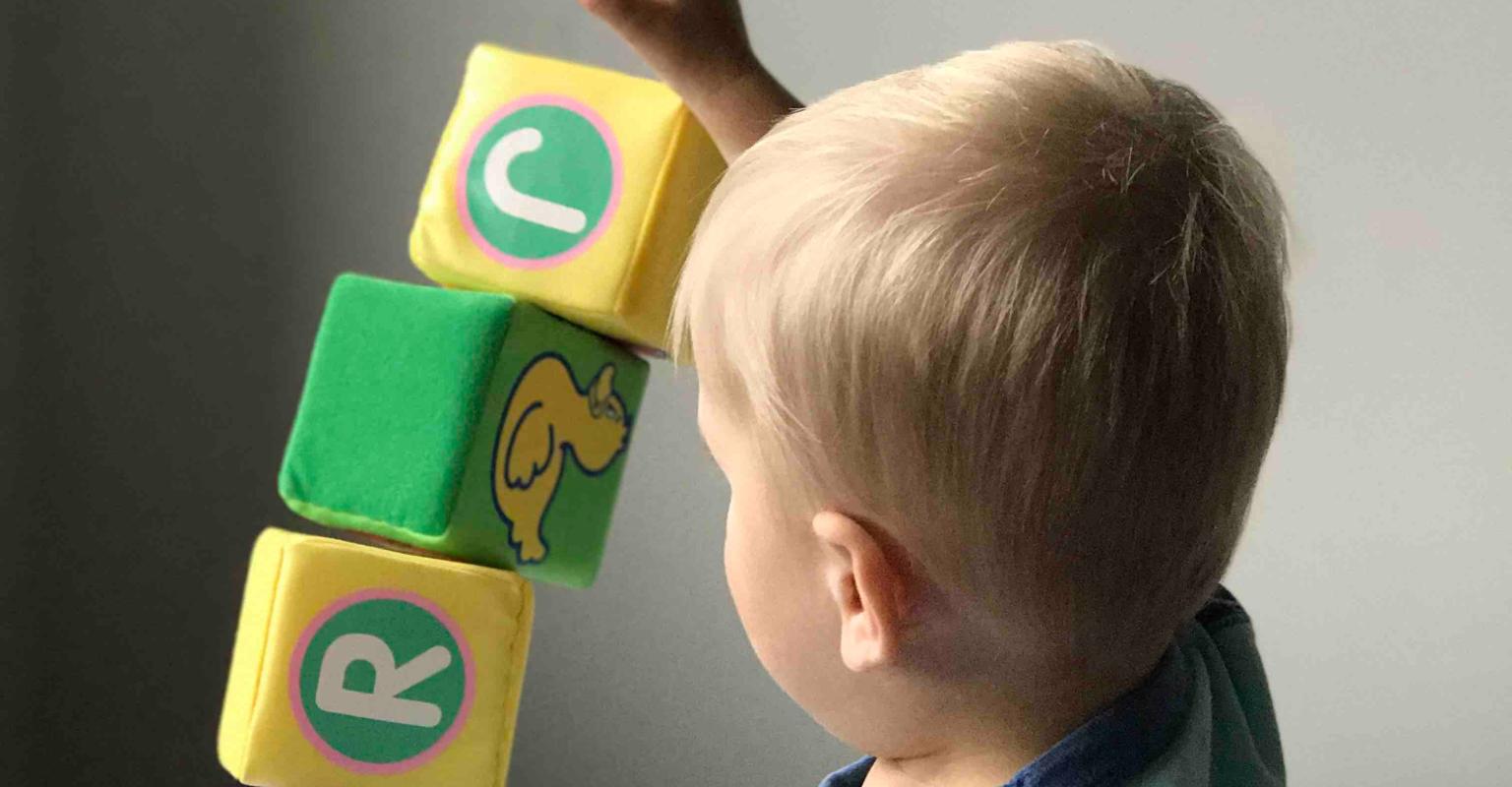 Child building a tower with blocks