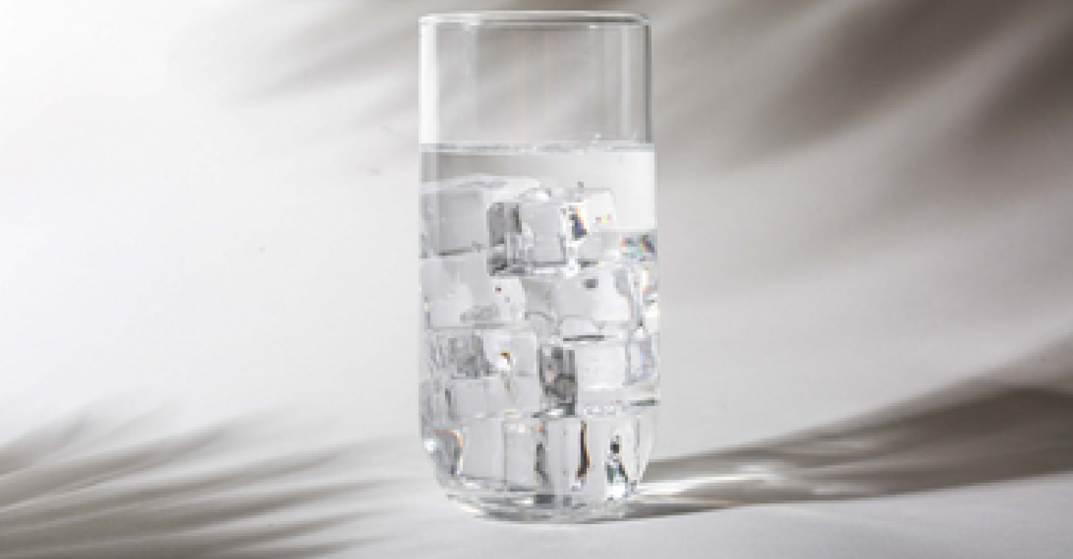 A cup with water and ice cubes