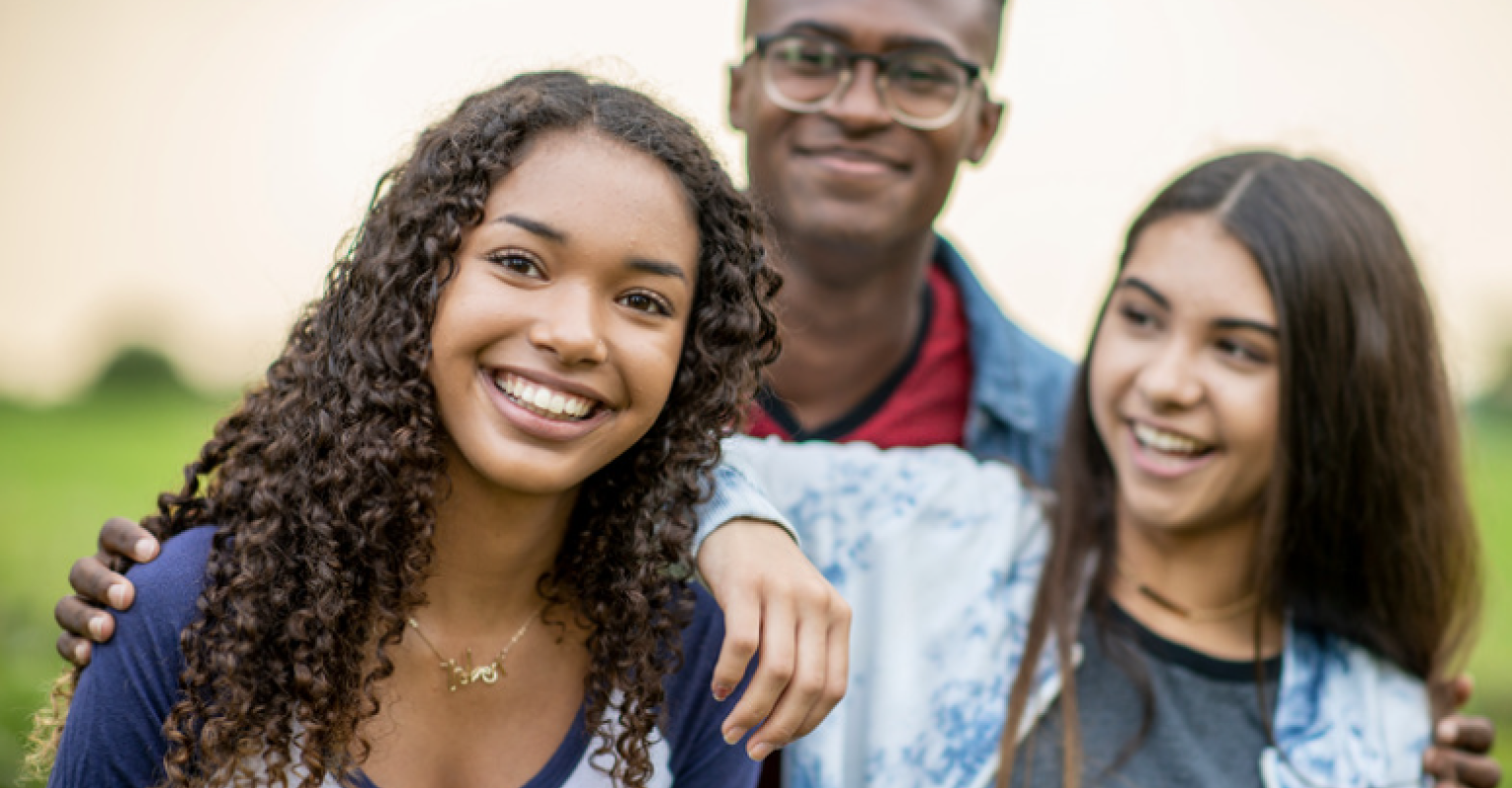three teenagers smiling