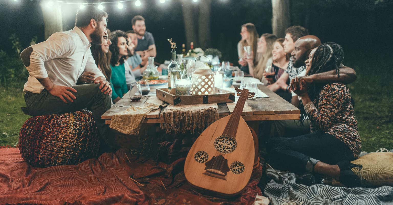 People around a table with candles