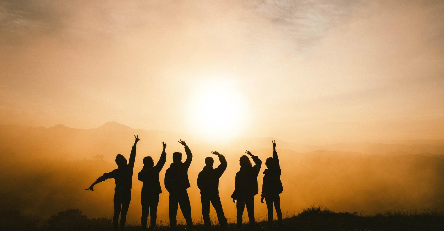 kids in front of a sunset