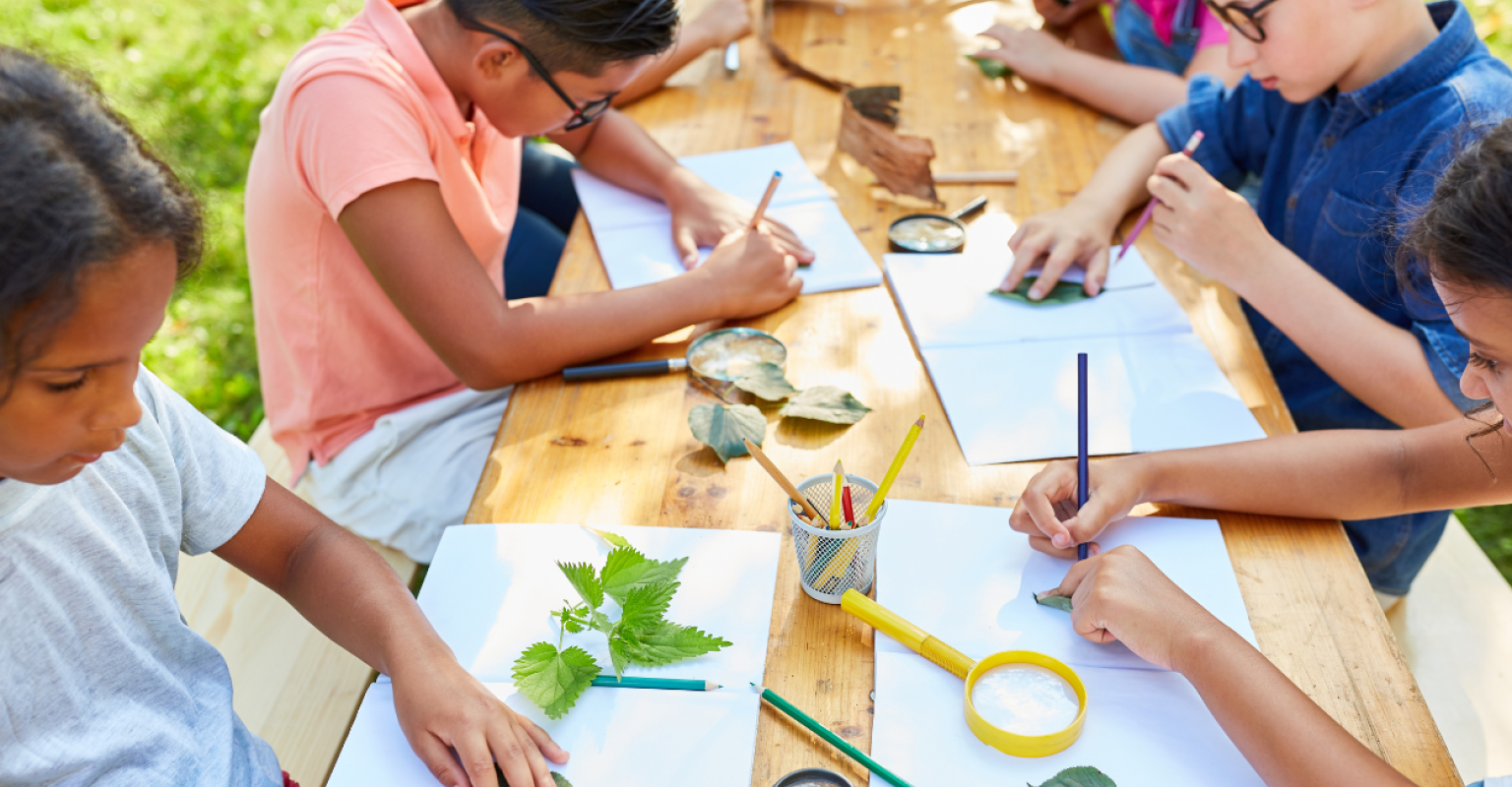 Kids at a picnic table making art