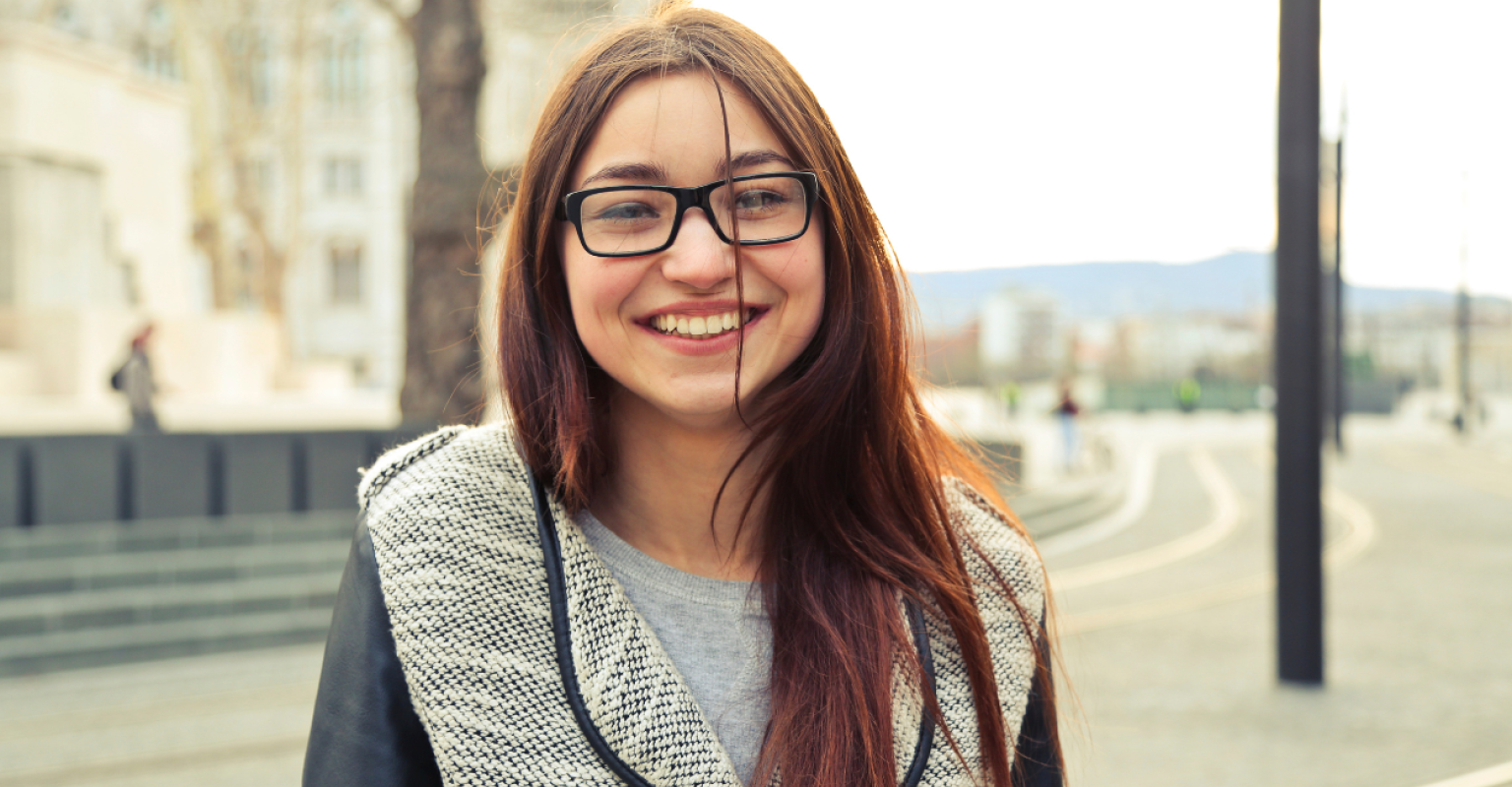 A teenage girl while looking into the camera