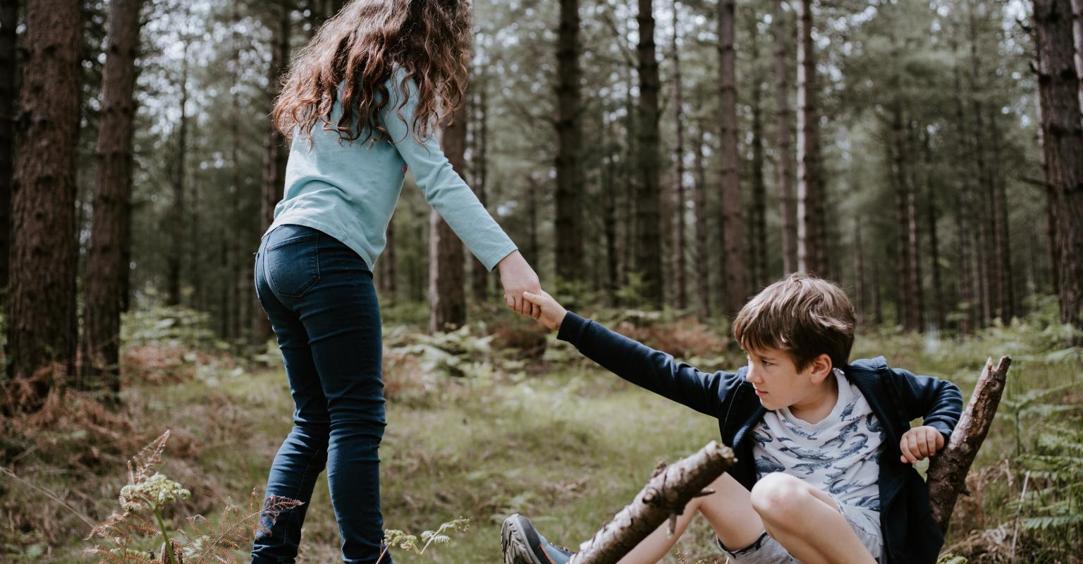 A child helping a child who has fallen