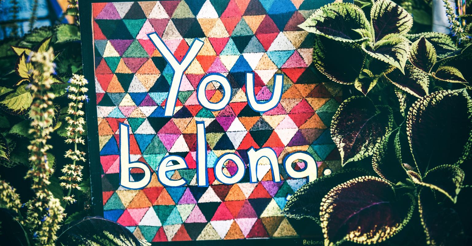 A colorful sign reading "you belong"