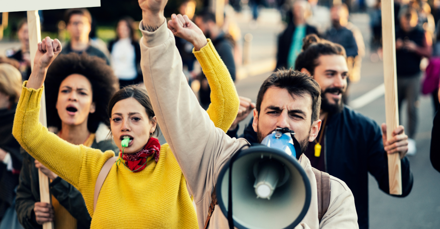 Students in protest with signs and a megaphone