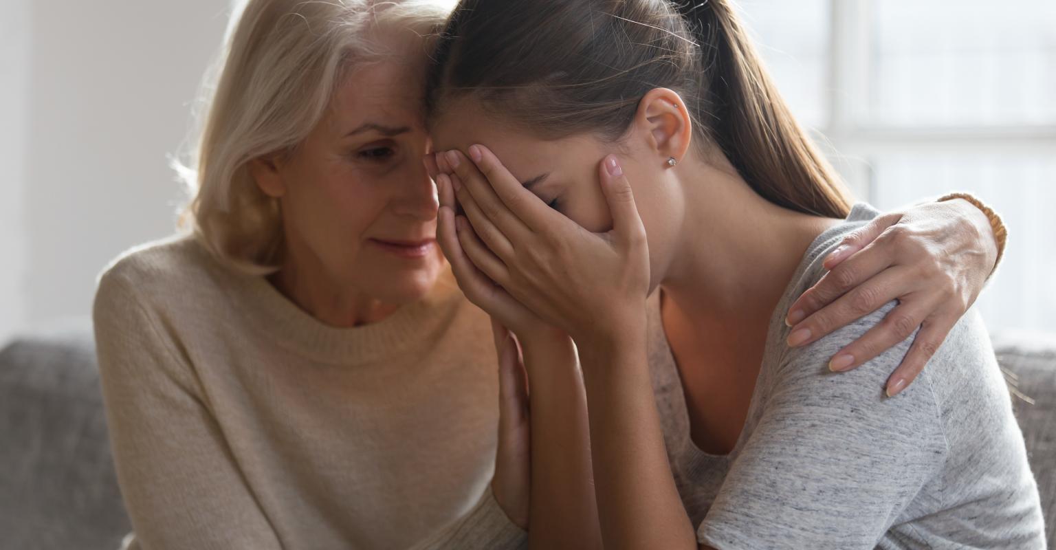 Mother comforting her teen