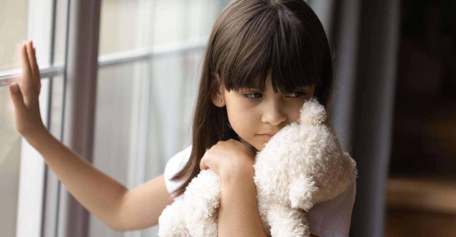 Sad girl with teddy bear