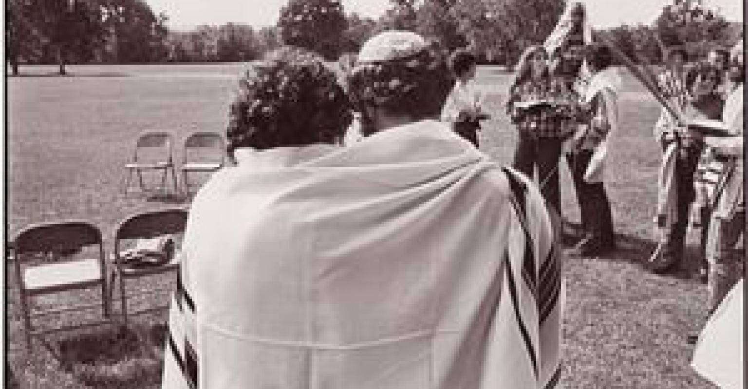 Two people wrapped in Tallit