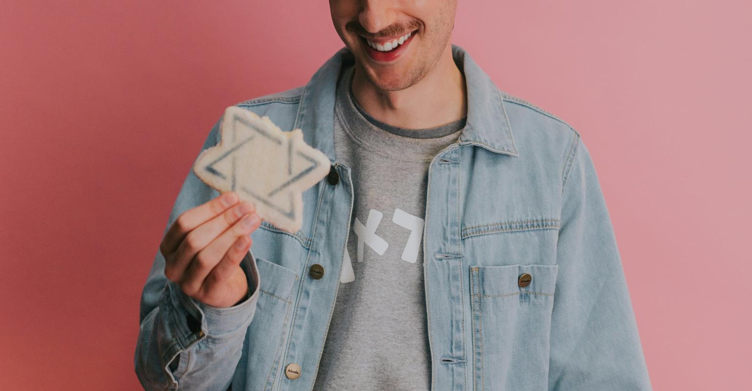 Man holding Jewish star cookie