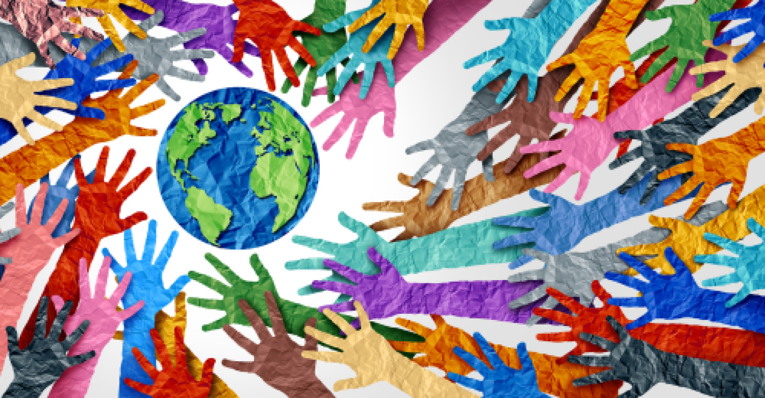 Multicolored hands reaching out towards earth