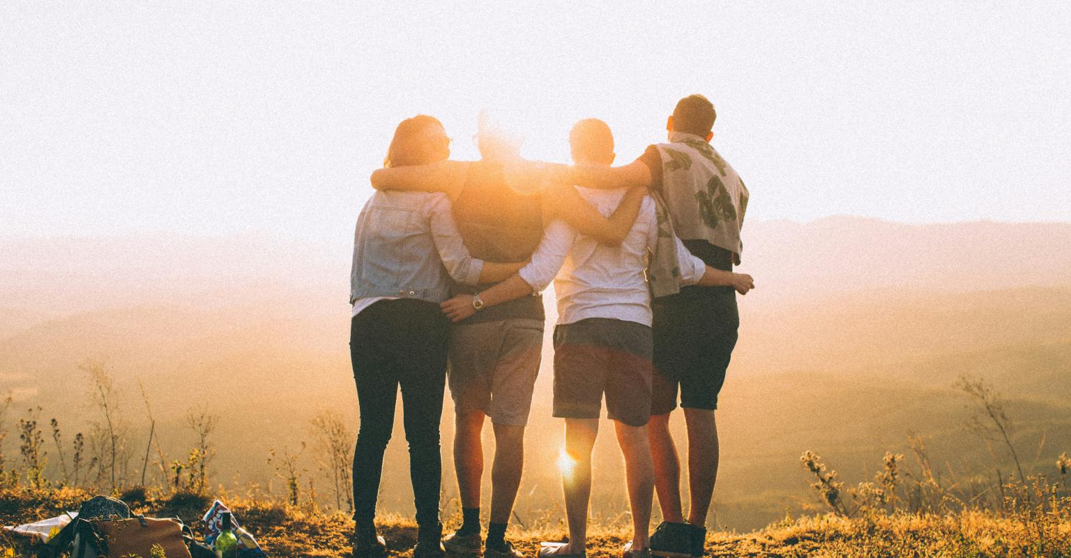 teens with arms around one another