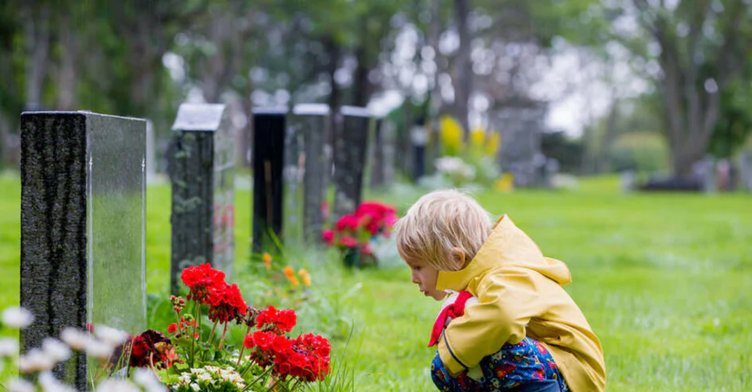 Little Boy in Front of Headstone